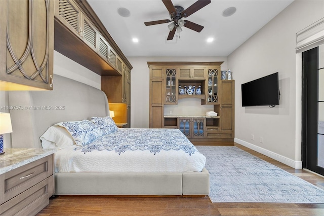 bedroom with hardwood / wood-style flooring and ceiling fan