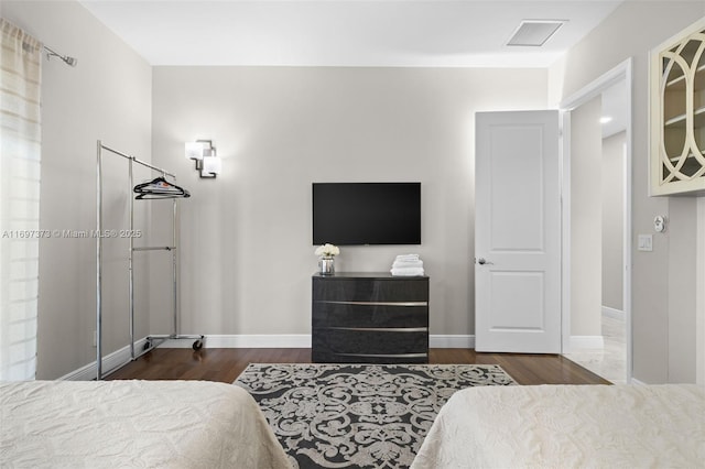 bedroom with dark hardwood / wood-style floors