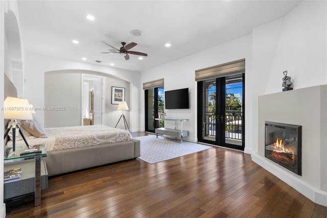 bedroom featuring access to outside, dark hardwood / wood-style floors, ceiling fan, and french doors