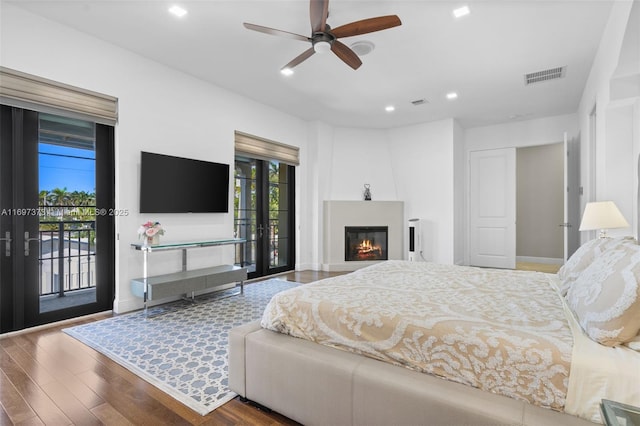 bedroom with ceiling fan, wood-type flooring, and access to exterior