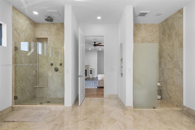 bathroom with a shower with door and ceiling fan