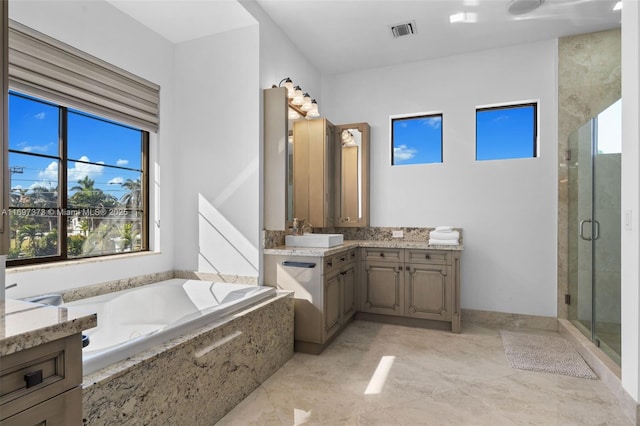 bathroom featuring vanity and separate shower and tub