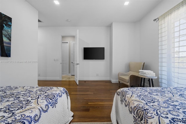 bedroom with dark hardwood / wood-style flooring