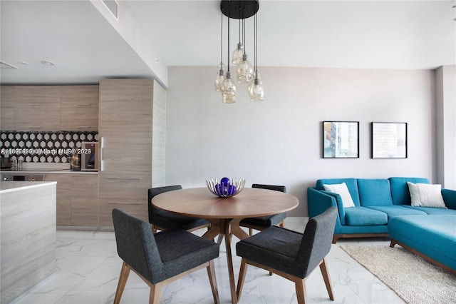 dining space with an inviting chandelier