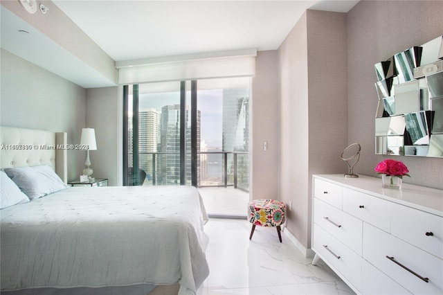 1300 S Miami Ave Unit 2104, Miami, FL 33130 - bedroom with light marble finish flooring, expansive windows, and baseboards