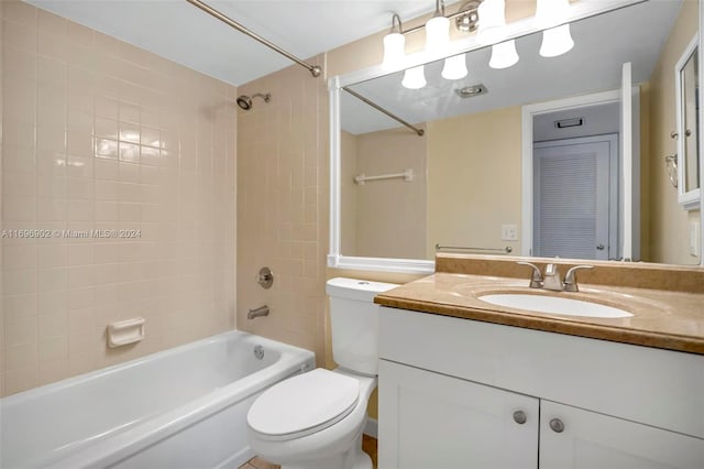 full bathroom with vanity, tiled shower / bath, and toilet