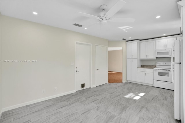 kitchen with white appliances, white cabinetry, and ceiling fan