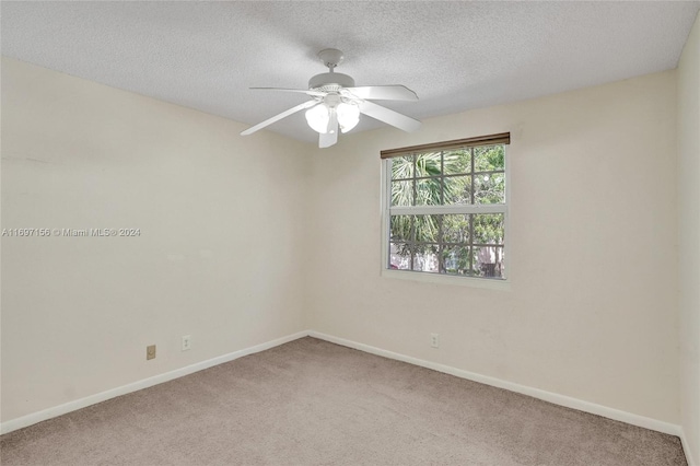 unfurnished room with carpet flooring, a textured ceiling, and ceiling fan