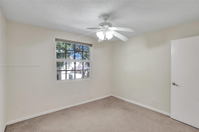 unfurnished room with light carpet, a textured ceiling, and ceiling fan