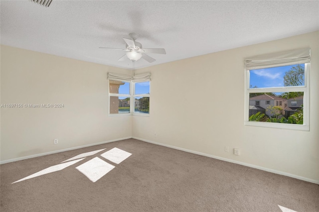 empty room featuring carpet floors, plenty of natural light, and ceiling fan