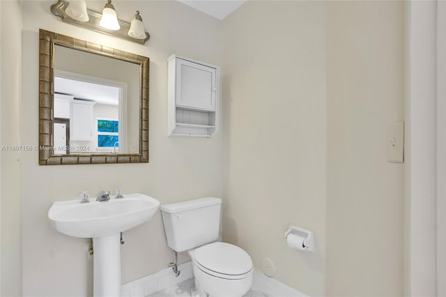 bathroom with tile patterned floors, toilet, and sink