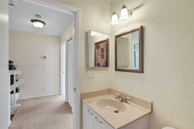 bathroom with vanity and a textured ceiling