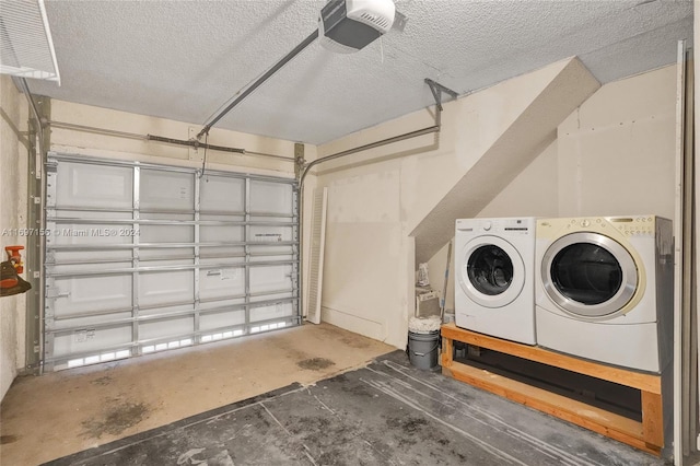 garage with washer and dryer and a garage door opener