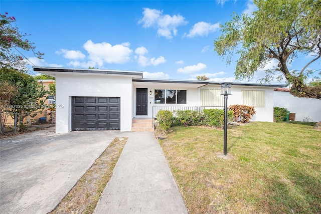 1369 NW 96th St, Miami, FL 33147 - view of front of home with stucco siding, a garage, driveway, and a front lawn