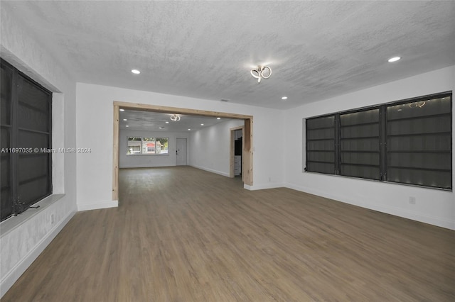 1369 NW 96th St, Miami, FL 33147 - empty room with a textured ceiling, wood finished floors, and recessed lighting