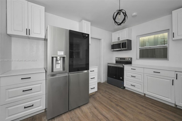 1369 NW 96th St, Miami, FL 33147 - kitchen with appliances with stainless steel finishes, dark wood finished floors, light countertops, and white cabinets