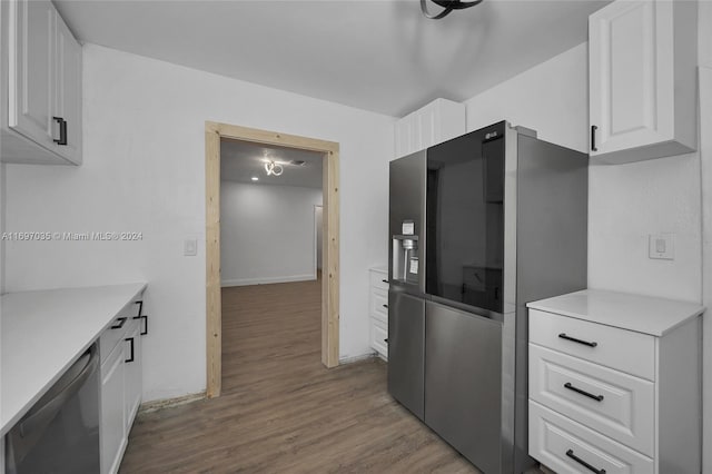 kitchen featuring hardwood / wood-style floors, white cabinetry, and stainless steel appliances