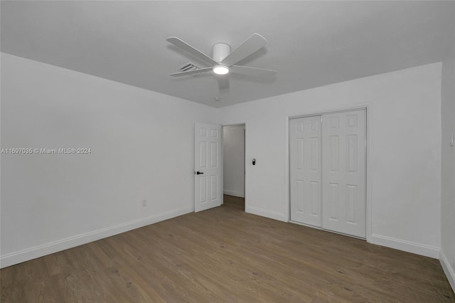 unfurnished bedroom with a closet, hardwood / wood-style flooring, and ceiling fan