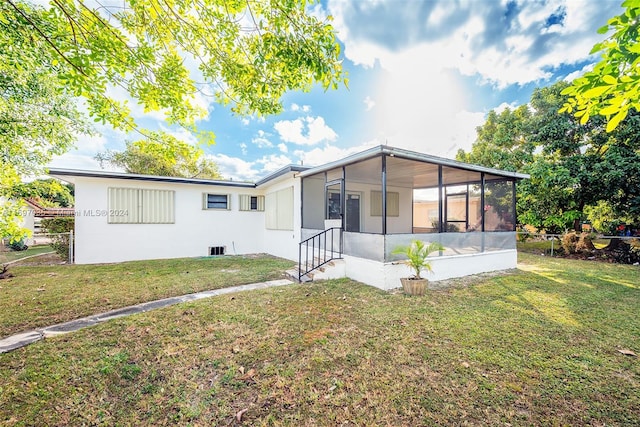 view of front of house featuring a front lawn and a sunroom