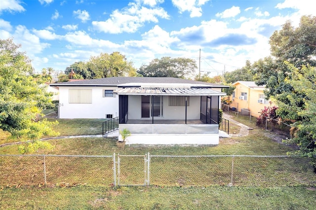 1369 NW 96th St, Miami, FL 33147 - back of house featuring a sunroom, a fenced backyard, and a gate