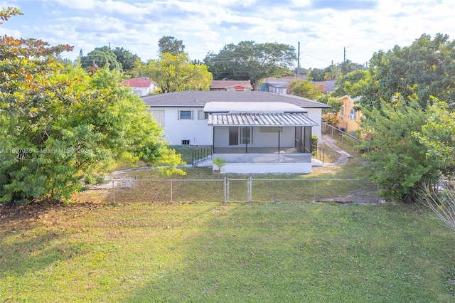 1369 NW 96th St, Miami, FL 33147 - rear view of house featuring a fenced backyard, a sunroom, a gate, a patio, and stucco siding