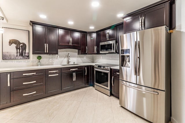 kitchen featuring decorative backsplash, dark brown cabinets, stainless steel appliances, and sink