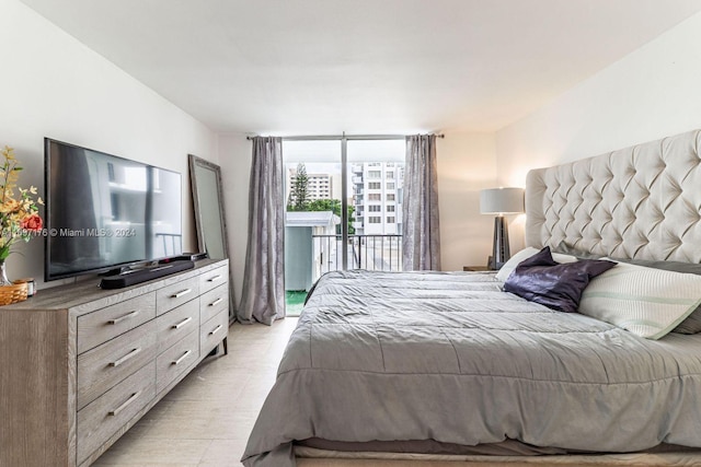 bedroom featuring access to exterior and light hardwood / wood-style floors