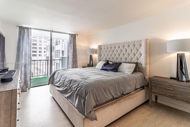 bedroom featuring access to exterior and floor to ceiling windows