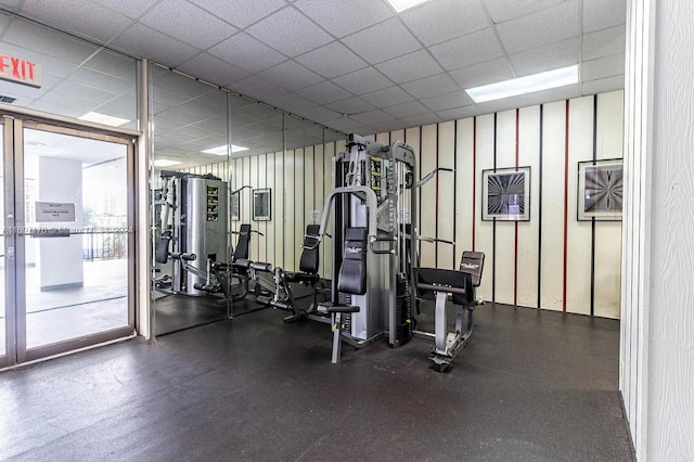 exercise room with a paneled ceiling