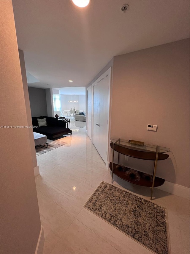 hall with light tile patterned flooring