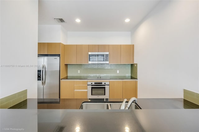1060 Brickell Ave Unit 4101, Miami, FL 33131 - kitchen featuring stainless steel appliances, tasteful backsplash, recessed lighting, and a sink