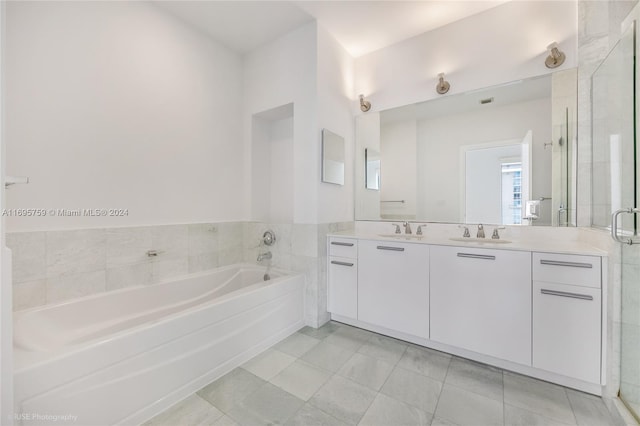 1060 Brickell Ave Unit 4101, Miami, FL 33131 - bathroom featuring double vanity, a bath, and a stall shower