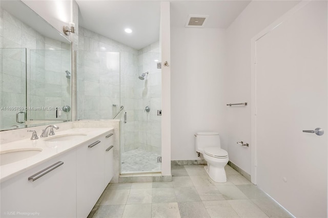 bathroom featuring tile patterned flooring, toilet, vanity, and walk in shower