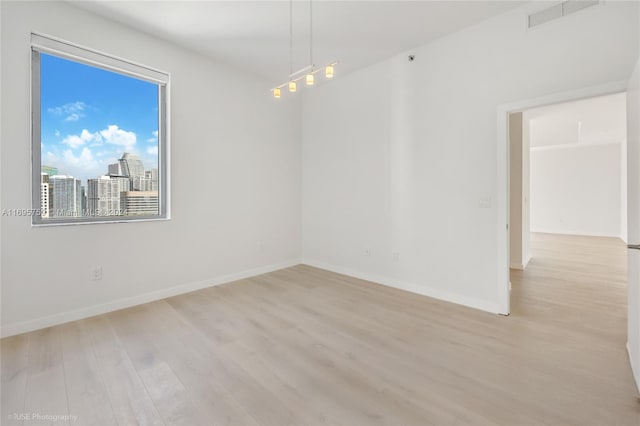 unfurnished room with light hardwood / wood-style floors