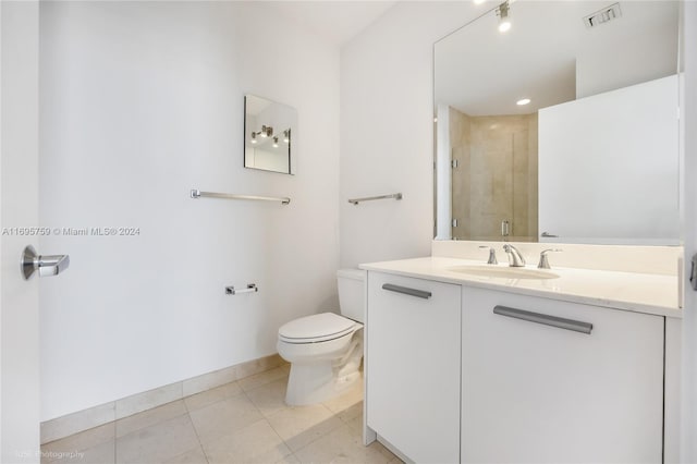 bathroom with walk in shower, tile patterned flooring, vanity, and toilet