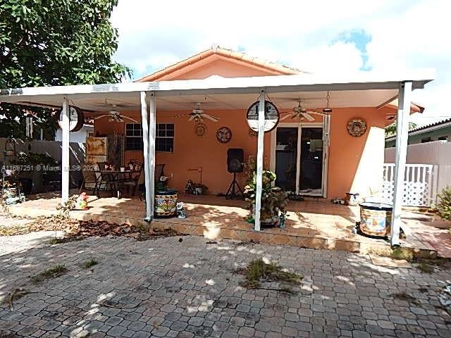 back of property featuring a patio area and ceiling fan