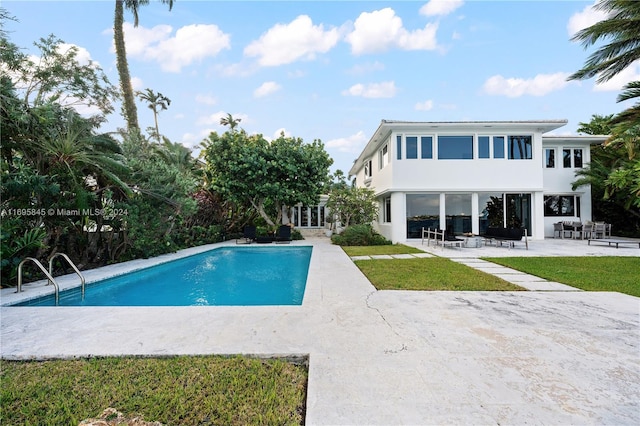 view of swimming pool with a yard and a patio