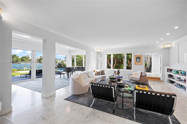 living room featuring a water view, ornamental molding, and a wealth of natural light