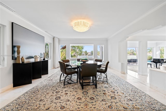 dining room with a healthy amount of sunlight and ornamental molding