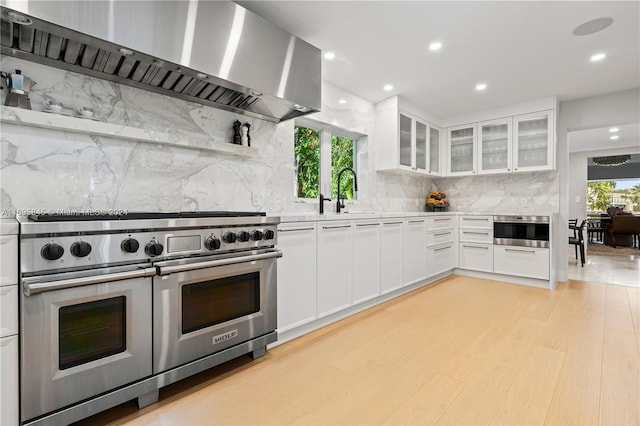 kitchen with white cabinetry, a healthy amount of sunlight, sink, and stainless steel appliances