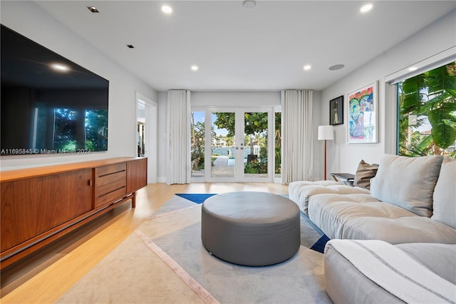 living room featuring french doors and light wood-type flooring