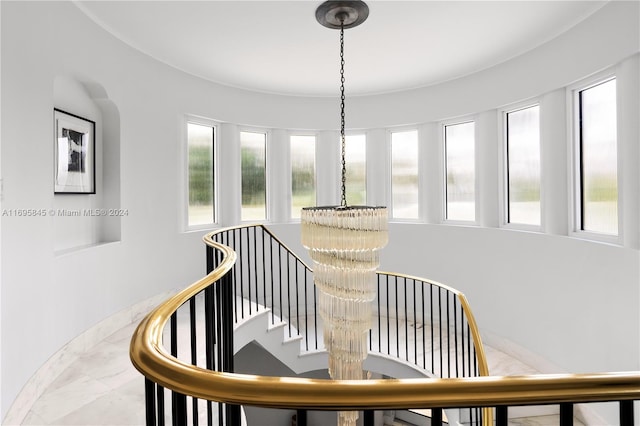 staircase with a chandelier