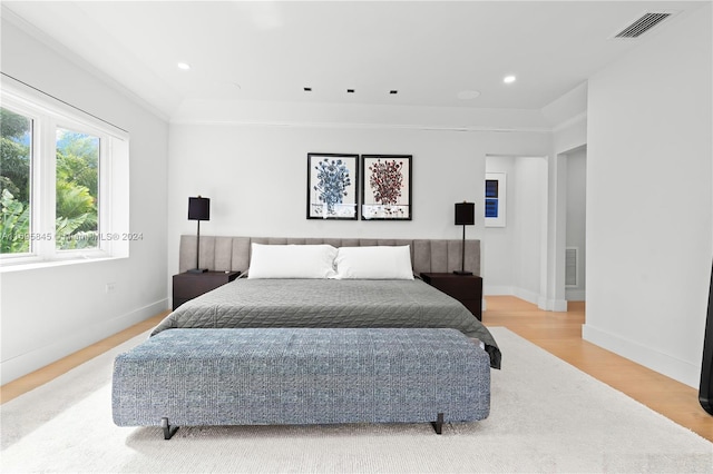 bedroom with crown molding and hardwood / wood-style flooring