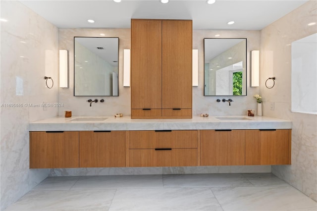 bathroom featuring vanity and tile walls