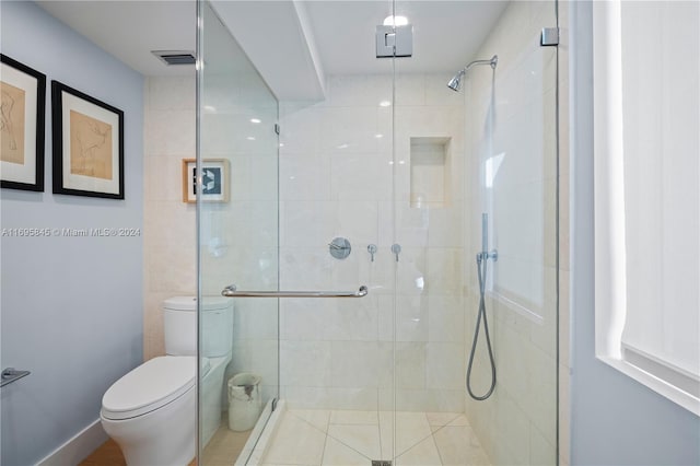 bathroom with toilet and an enclosed shower