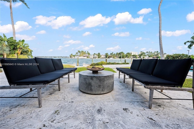 view of patio featuring outdoor lounge area and a water view