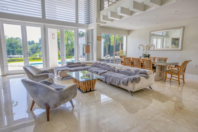 living room with french doors and a high ceiling