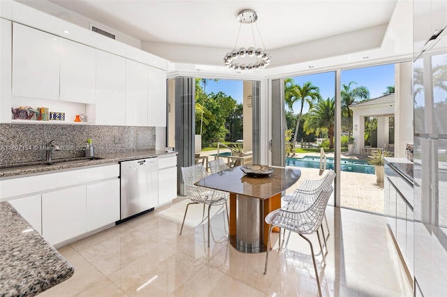 dining space featuring a healthy amount of sunlight and sink