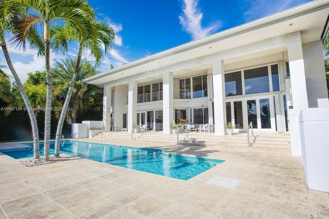 view of pool featuring a patio area and french doors