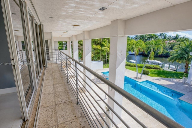 view of swimming pool featuring a water view